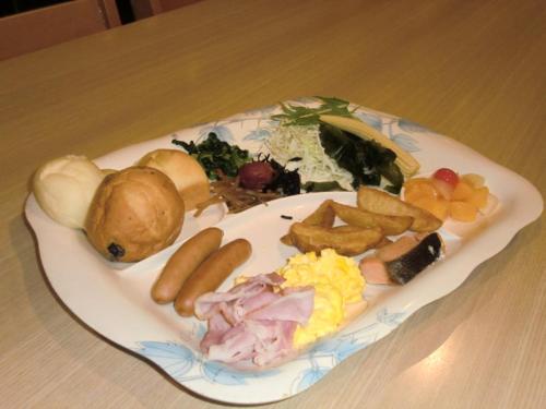 a plate of food on a wooden table at Osaka International Youth Hostel in Takaishi