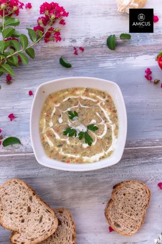 a bowl of soup with two slices of bread at Hotel Amicus in Mostar