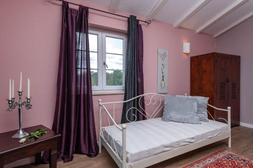 a bedroom with a white bed and a window at Villa Branca 6+2 in Krnica
