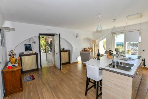 a kitchen with a sink and a counter top at Praialonga Suites with Pool and Garden in Le Castella