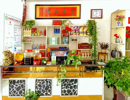 a shop with a counter with plants on it at Rime Island Manzhaosongju Inn in Jilin