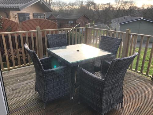 a patio with a table and chairs on a deck at 7 The Oaks in North Walsham