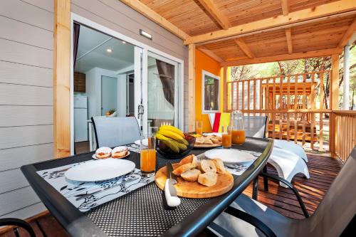 a black table with food on it on a porch at Mobile Homes Bi Village - Adriatic Kampovi in Fažana