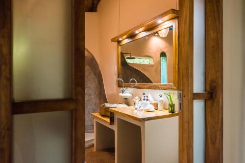 a bathroom with a sink and a mirror at Lemala Wildwaters Lodge in Kangulumira