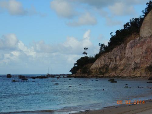 people are swimming in the water at a beach at Pousada Boutique Recanto Do Encanto - GAMBOA - Morro de São Paulo in Morro de São Paulo