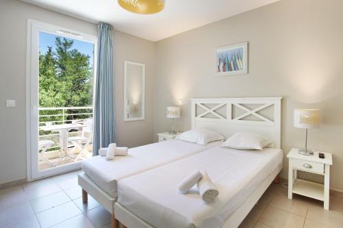 Postel nebo postele na pokoji v ubytování Résidence Odalys Les Océanides