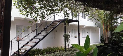 a staircase leading up to a white house at Ecopousada Miriti in Belém
