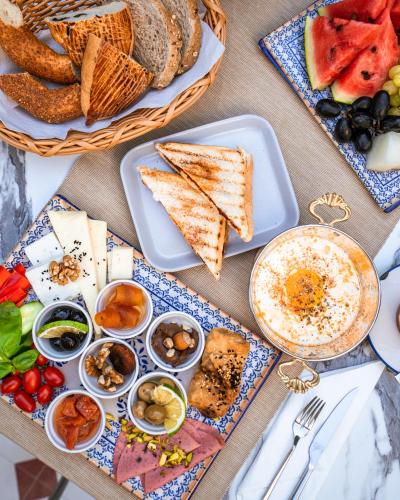 a table topped with plates of food and bread at KIANA KALEİÇİ in Antalya