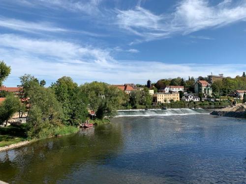 a boat on a river with a waterfall at Hotel garni Zum Rebstock in Naumburg