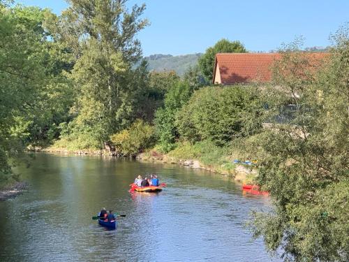 a group of people in kayaks on a river at Hotel garni Zum Rebstock in Naumburg