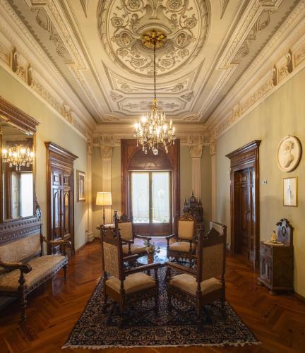 a living room with a table and chairs and a ceiling at Hotel Villa Quiete in Montecassiano