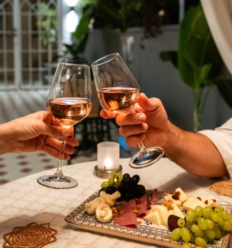 two people holding up glasses of wine at KIANA KALEİÇİ in Antalya