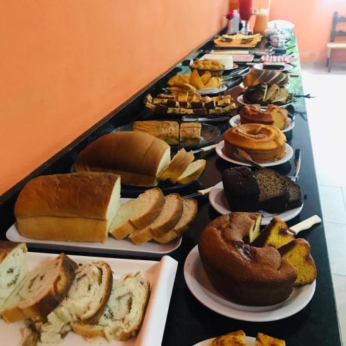 a long table filled with different types of pastries at Pousada Serraninhos in Santa Leopoldina