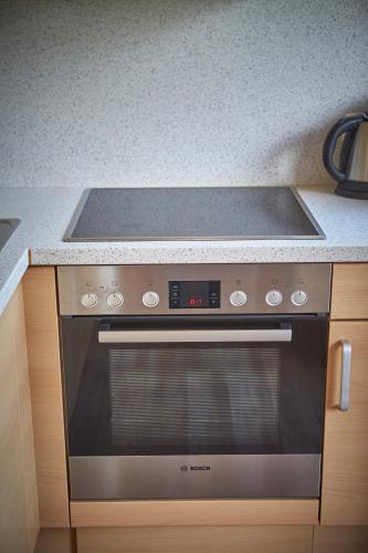 a kitchen with a stove top oven in a kitchen at Appartements Christine in Maishofen