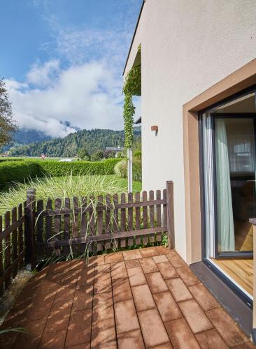 a porch with a wooden bench next to a window at Appartements Christine in Maishofen