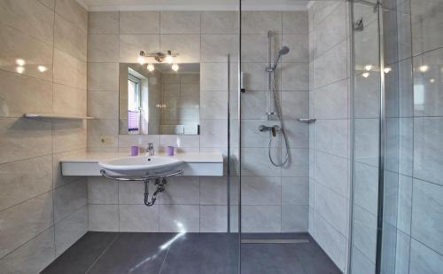 a bathroom with a sink and a shower at Appartements Christine in Maishofen