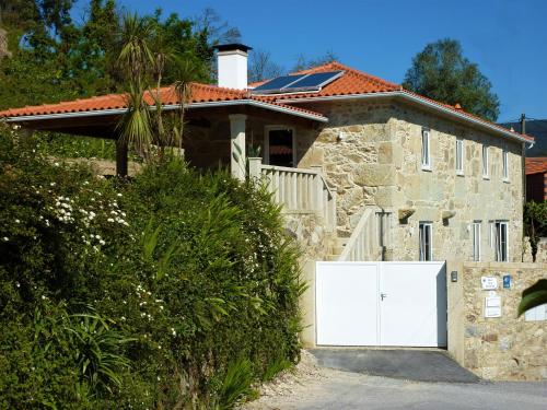 a house with a white garage door in front of it at Quinta Labruja in Labruja