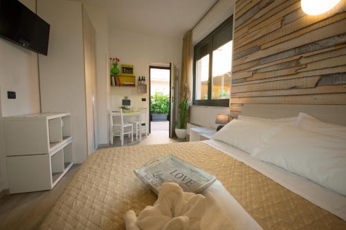 a bedroom with a large bed with a wooden wall at Alba Serena Camere in Alba