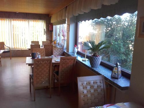 a kitchen with a table and chairs and a window at Miramar in Dahme