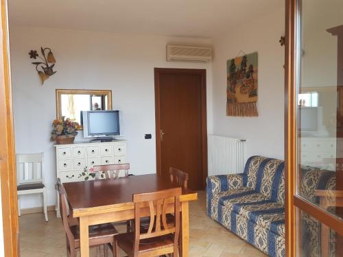 a living room with a table and a couch at Saturnia Tuscany Country House in Saturnia