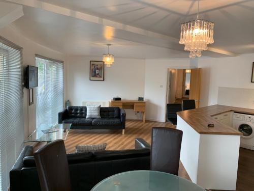 a living room with a couch and a table at Caledonian Apartment in Perth