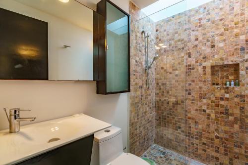 a bathroom with a sink and a shower at Duplex w Rooftop Plunge Pool – Walk to Beach in Playa del Carmen