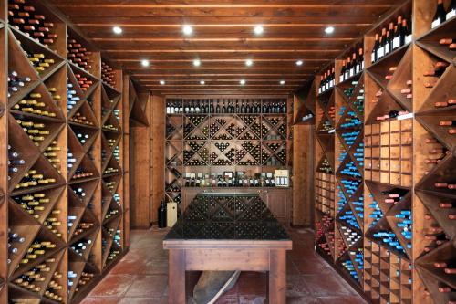 a wine cellar with a table and a lot of wine bottles at Herdade da Calada in Azaruja
