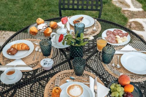 a table topped with plates of food and drinks at B&B Gli Archi in Abbadia San Salvatore