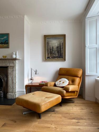 a living room with a couch and a table at Stunning Georgian Flat in The Heart of Midhurst Old Town in Midhurst