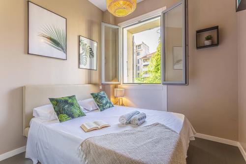 a bedroom with a bed with two books on it at MY CASA - GAMBETTA 33 in Nice