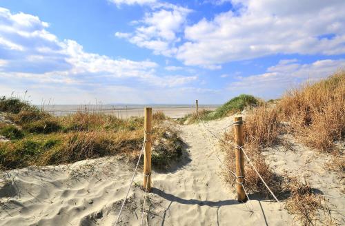 a fence in the sand on a beach at Stunning Georgian Flat in The Heart of Midhurst Old Town in Midhurst