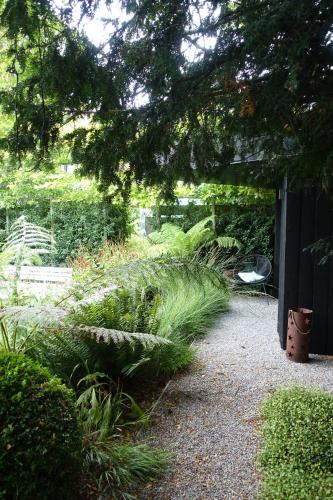 a garden with some plants and a fence at Bed and garden in Knokke-Heist