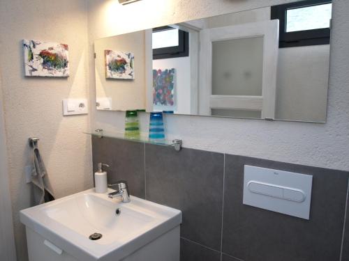 a bathroom with a sink and a mirror at Las Pardelas, Ferienhaus mit Meer-, Küsten- und Bergblick im grünen Norden Teneriffas in Las Cruces