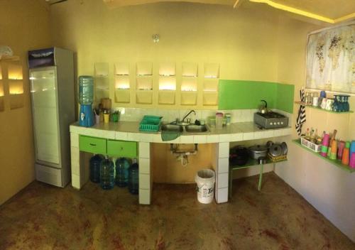 a toy kitchen with a sink and a refrigerator at Fata Morgana Eco Hotel in Las Terrenas