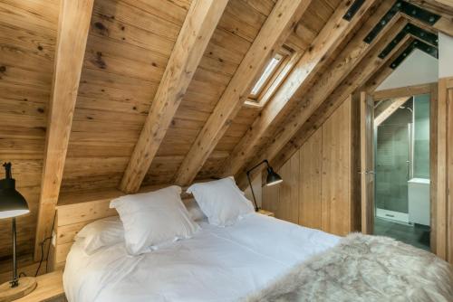 a bed in a room with wooden walls at Mike by Totiaran in Naut Aran