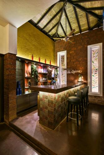 a bar in a room with a brick wall at The Fern Samali Resort in Dapoli
