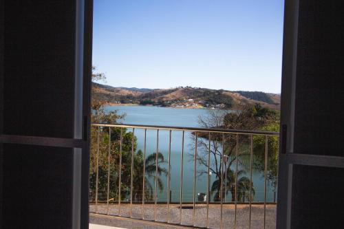 a view of a lake from a balcony at Pousada Mar de Minas in Capitólio