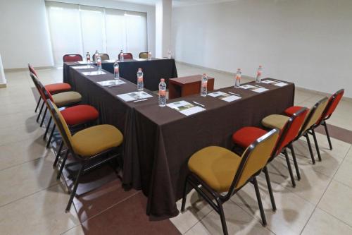 a long table with chairs and bottles of water on it at Staybridge Suites Queretaro by IHG in Querétaro
