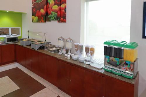 a kitchen with a counter with some food at Staybridge Suites Queretaro by IHG in Querétaro