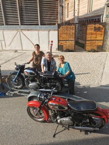 a group of people standing next to parked motorcycles at Logis Hotel Nature Cathare in Léran