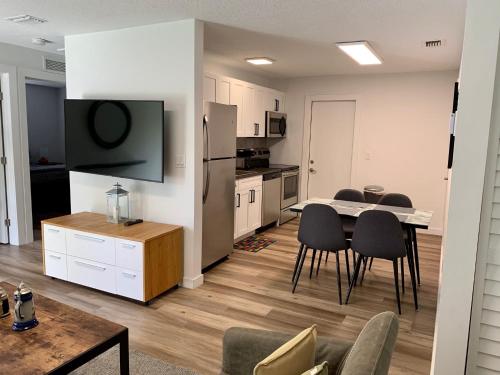 a kitchen and living room with a table and chairs at Harbourside Flats in Fort Lauderdale