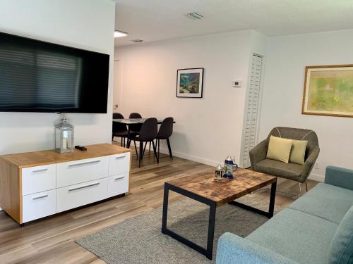a living room with a couch and a table at Harbourside Flats in Fort Lauderdale