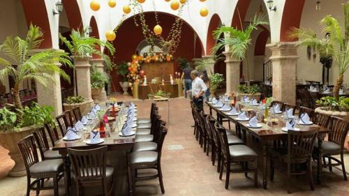 a dining room with tables and chairs in a building at Hotel Santa Elena in El Fuerte