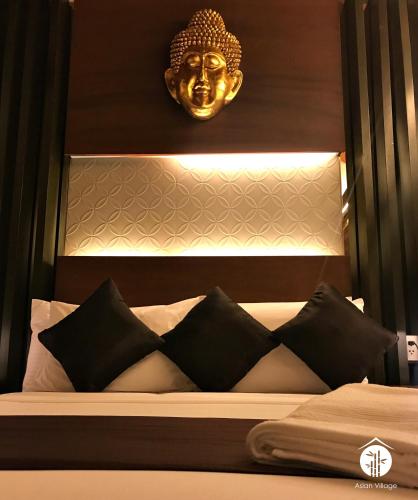 a bedroom with a bed with a gold mask above it at Asian Village Tagaytay in Tagaytay