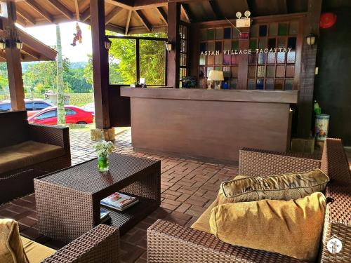 a restaurant with chairs and a table and a bar at Asian Village Tagaytay in Tagaytay