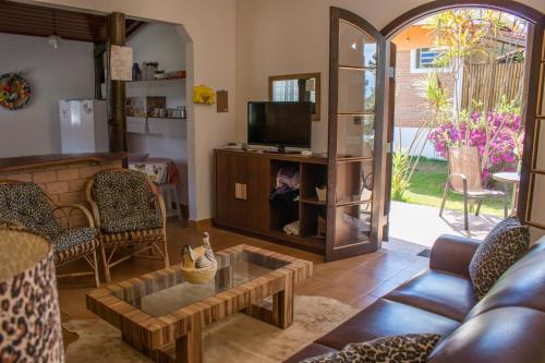 a living room with a couch and a table at Pousada Sonho Meu in Itanhandu
