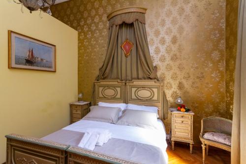a bedroom with a large bed with a canopy at Casa della Contessa B&B in Turin