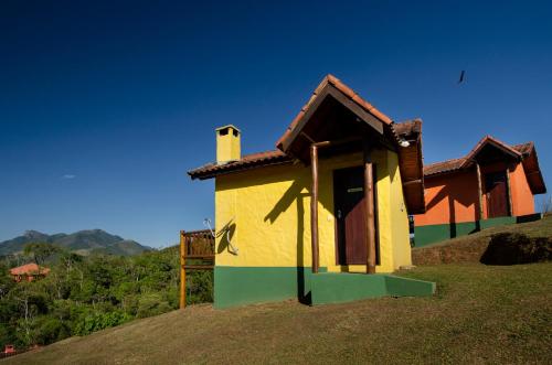 a small house sitting on top of a hill at Pousada Lua de Minas in Visconde De Maua