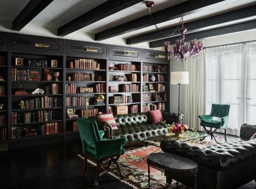 a living room with a couch and book shelves at Commodore Perry Estate, Auberge Resorts Collection in Austin