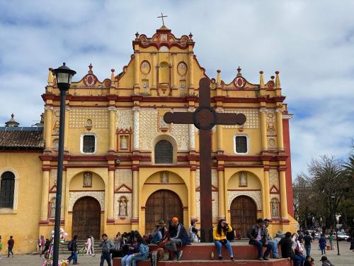a group of people sitting in front of a building at Hotel Villa Murano in San Cristóbal de Las Casas